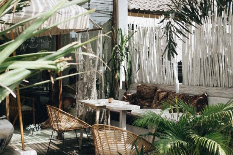 Terrasse et mobilier au tons beige et blancs avec plusieurs plantes verte